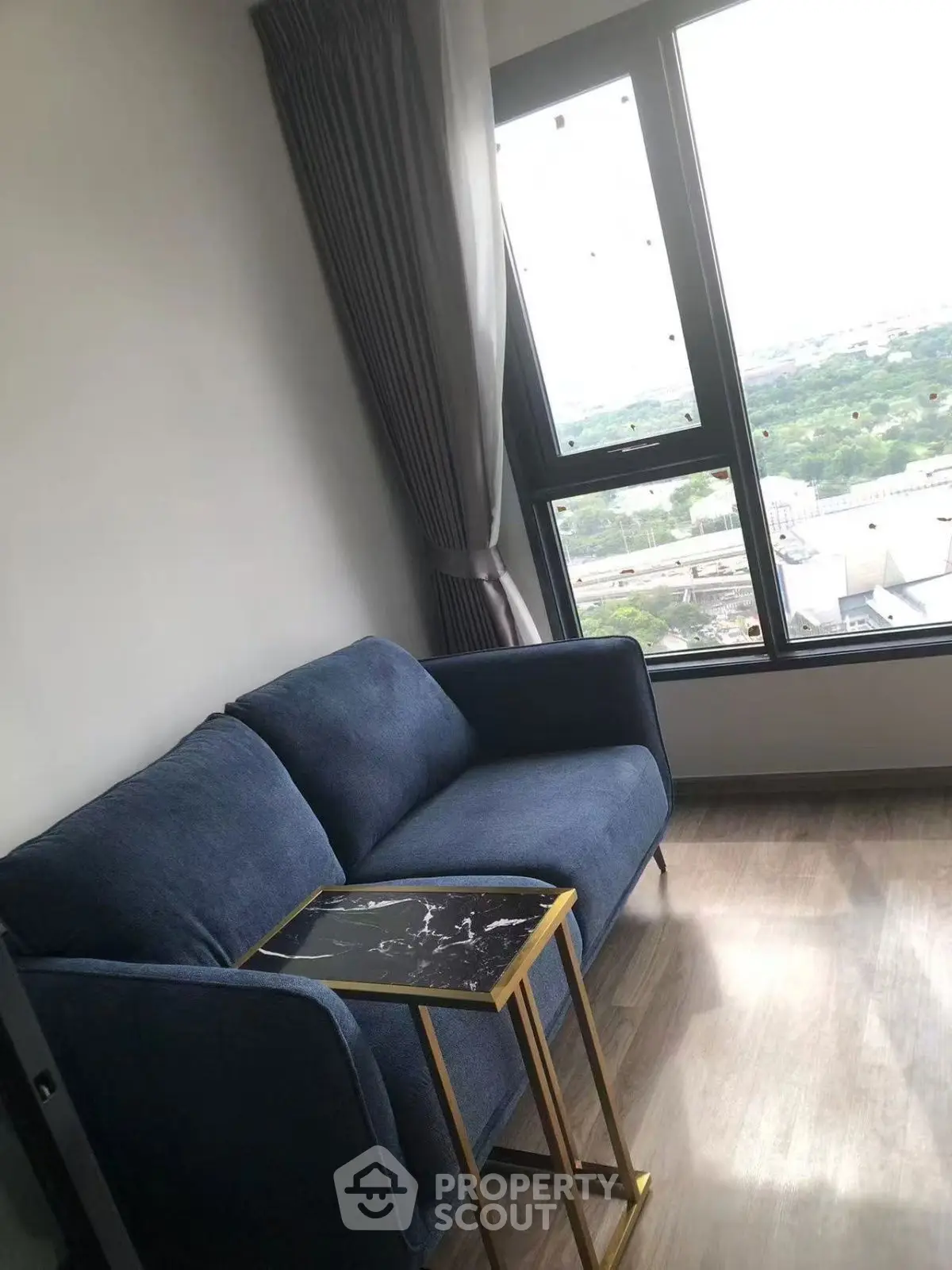 Cozy living room with blue sofa and stunning window view