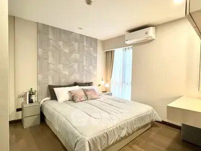 Modern bedroom with stylish decor and natural light