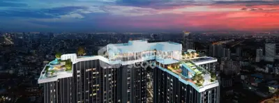 Stunning rooftop view of a modern high-rise building at sunset, featuring luxurious amenities and panoramic cityscape.