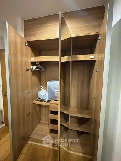 Spacious wooden walk-in closet with ample storage and modern design