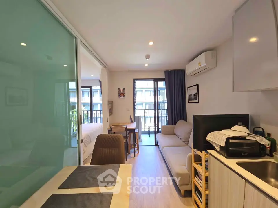 Modern open-plan living room with balcony in a stylish apartment