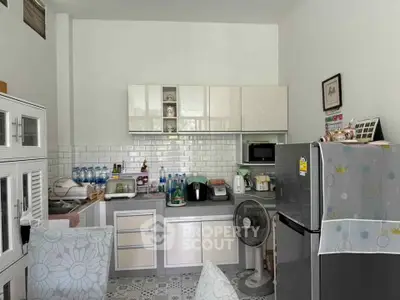 Charming kitchen with modern appliances and stylish cabinetry, perfect for culinary enthusiasts.