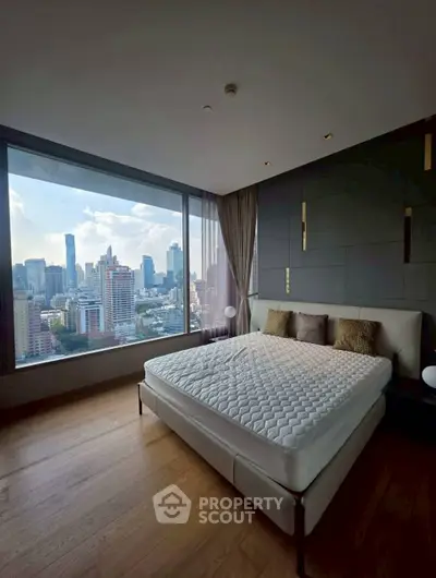 Luxurious bedroom with stunning city view from floor-to-ceiling windows, featuring modern decor and cozy ambiance.