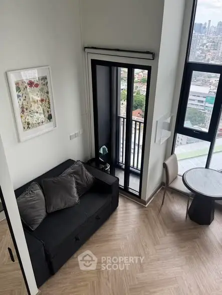 Modern high-rise apartment with stylish living room and stunning city view.