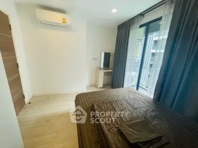 Modern bedroom with air conditioning and balcony view in stylish apartment