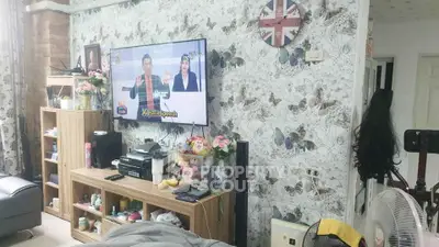 Charming living room with floral wallpaper and modern entertainment setup