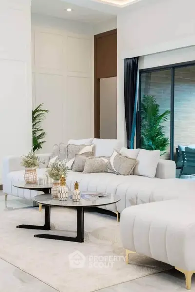 Luxurious modern living room with plush white sofas and elegant decor
