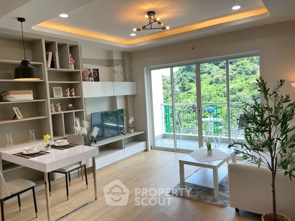 Modern living room with stylish decor and balcony view of lush greenery.