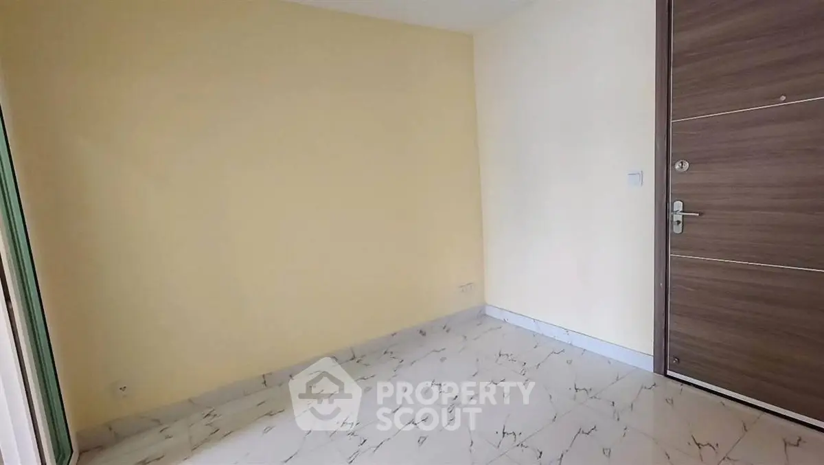Minimalist empty room with marble flooring and wooden door, perfect for customization.