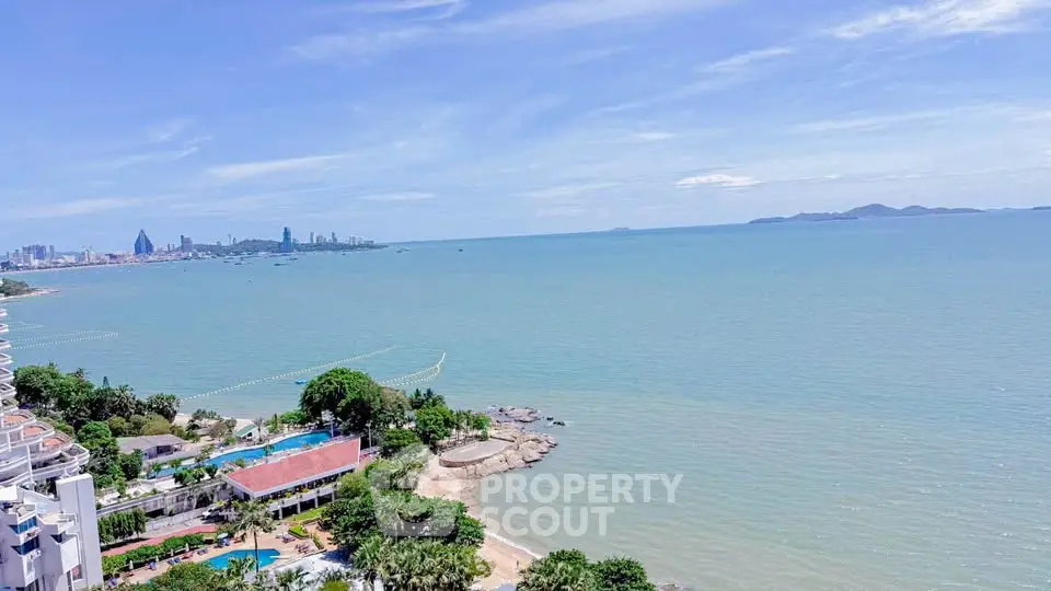 Stunning ocean view from high-rise building overlooking city skyline and coastline.