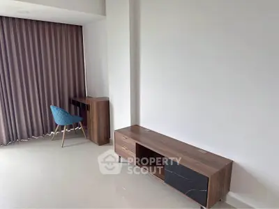 Modern minimalist living room with sleek furniture and elegant curtains