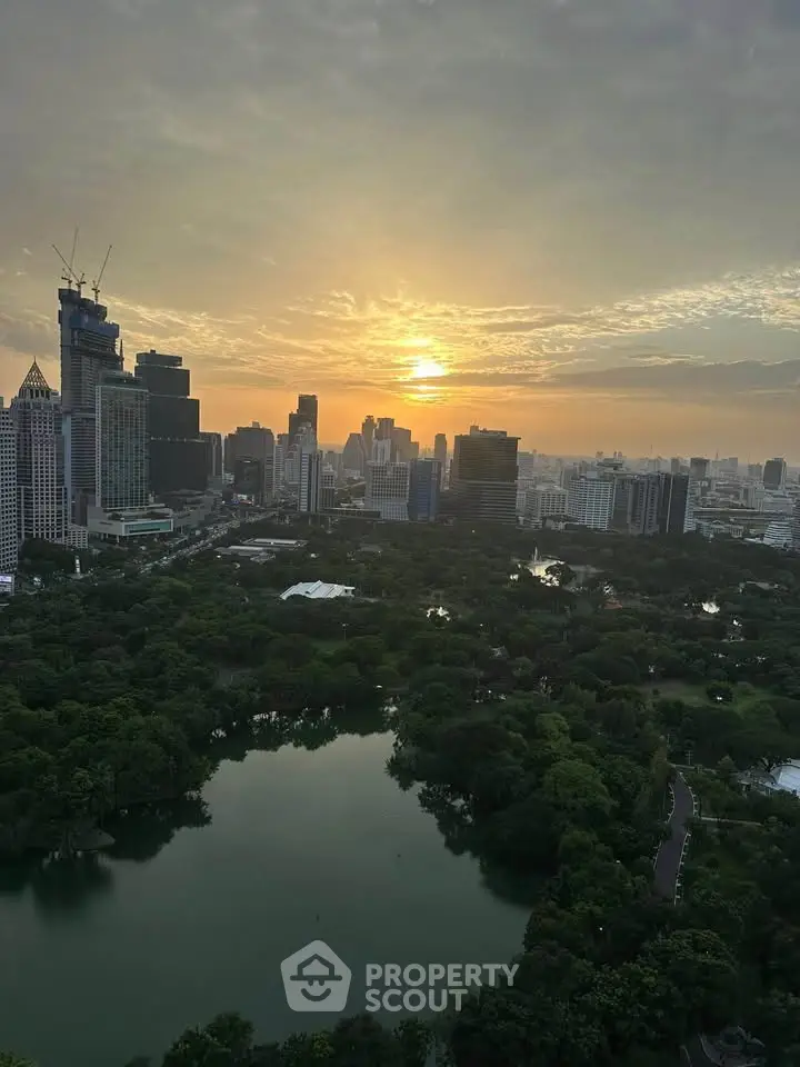 Stunning cityscape view with lush green park and skyline at sunset, perfect for urban living enthusiasts.