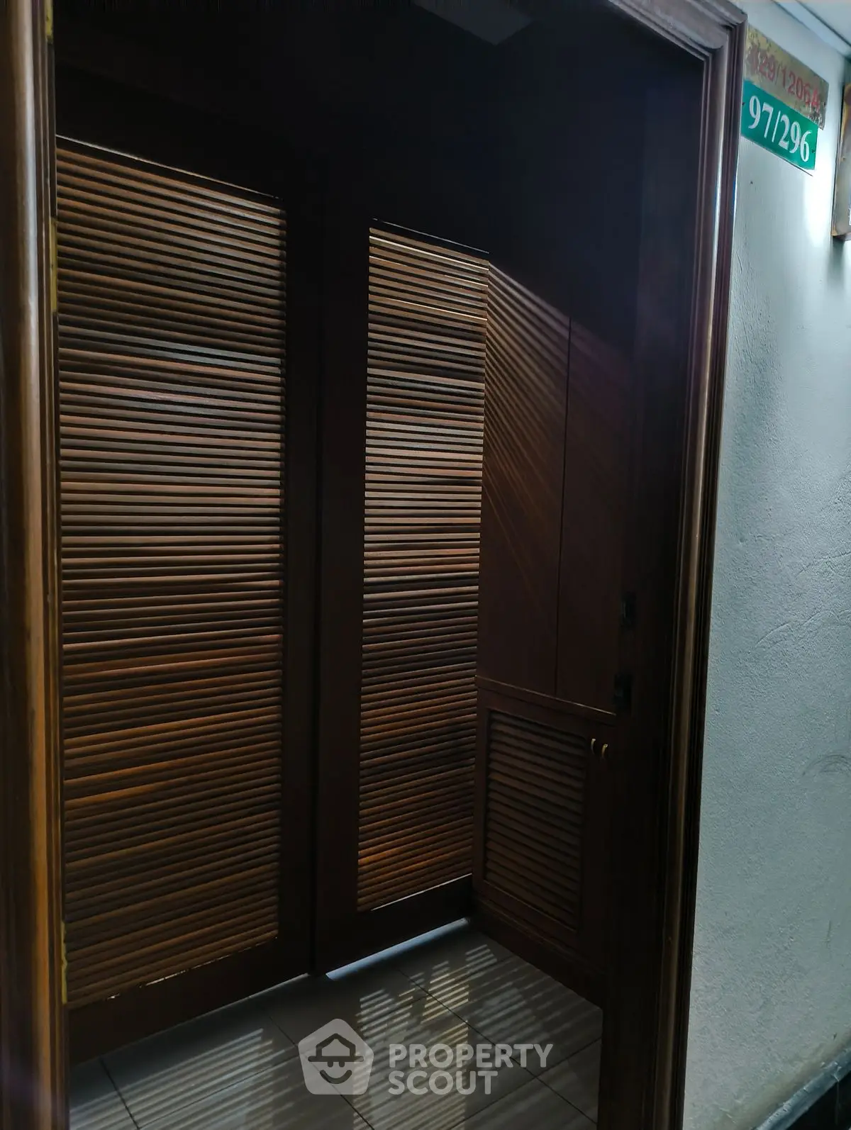 Elegant wooden elevator entrance with modern design in a residential building.