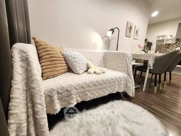 Cozy living room with stylish sofa and dining area in modern apartment