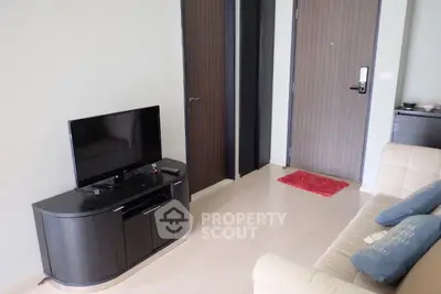 Modern living room with sleek TV stand and cozy sofa in stylish apartment.