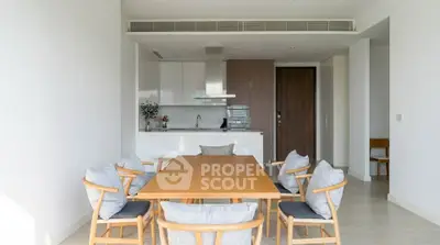 Modern dining area with sleek kitchen in open layout apartment