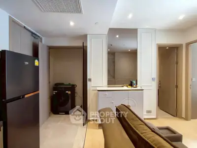 Modern living room with integrated laundry area and sleek appliances