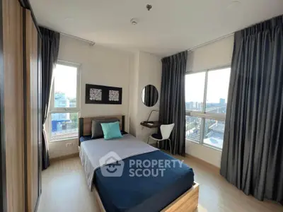 Modern bedroom with large windows and stylish decor in urban apartment