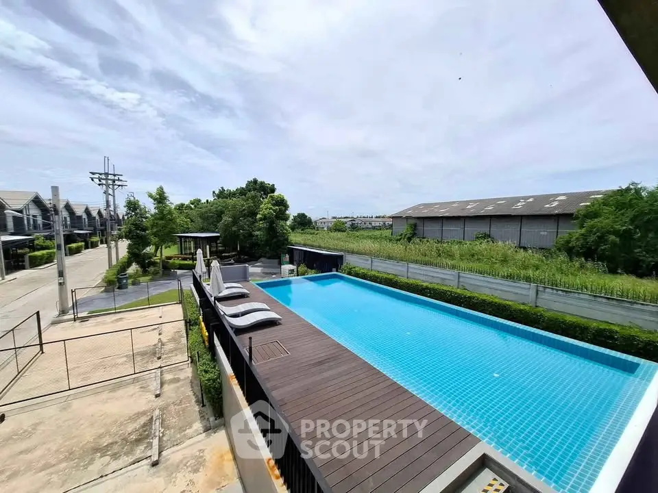 Stunning outdoor pool with modern design and serene surroundings in a residential area.