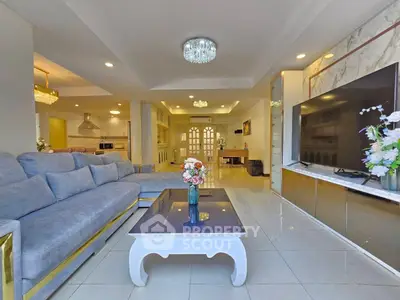 Spacious living room with elegant decor and modern amenities, perfect for family gatherings.