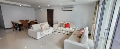 Spacious living room with modern furniture and large windows for natural light.