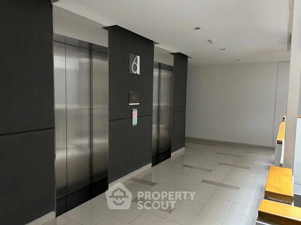 Modern building elevator lobby with sleek design and polished floors.