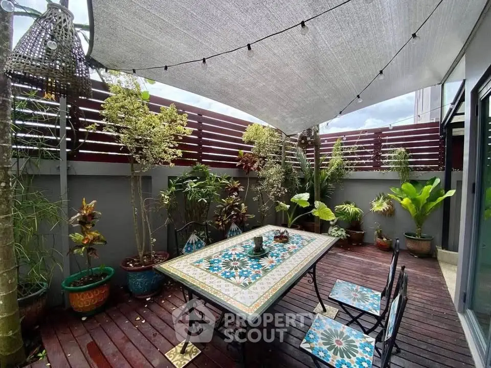 Charming garden patio with stylish mosaic table and lush greenery