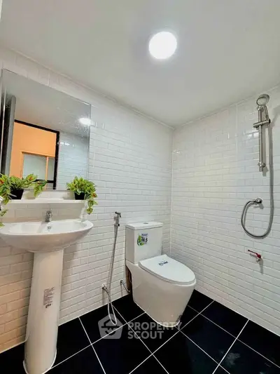 Modern bathroom with sleek white tiles and contemporary fixtures