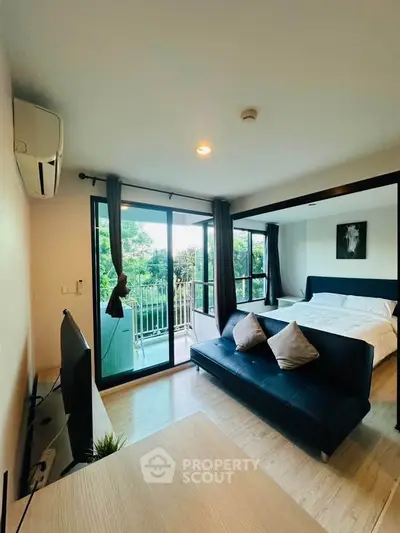 Modern studio apartment with balcony and lush green view