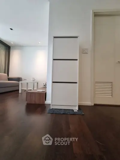 Modern living room with sleek furniture and wooden flooring