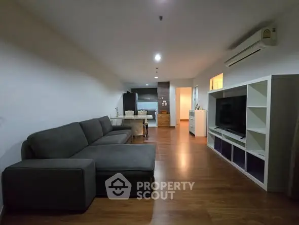 Spacious living room with modern furniture and open kitchen layout