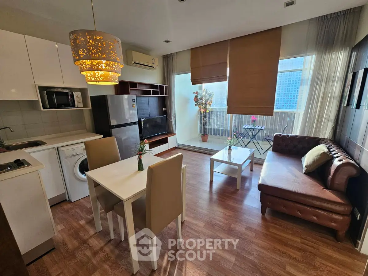 Chic modern living room with open kitchen, stylish decor, and balcony view.