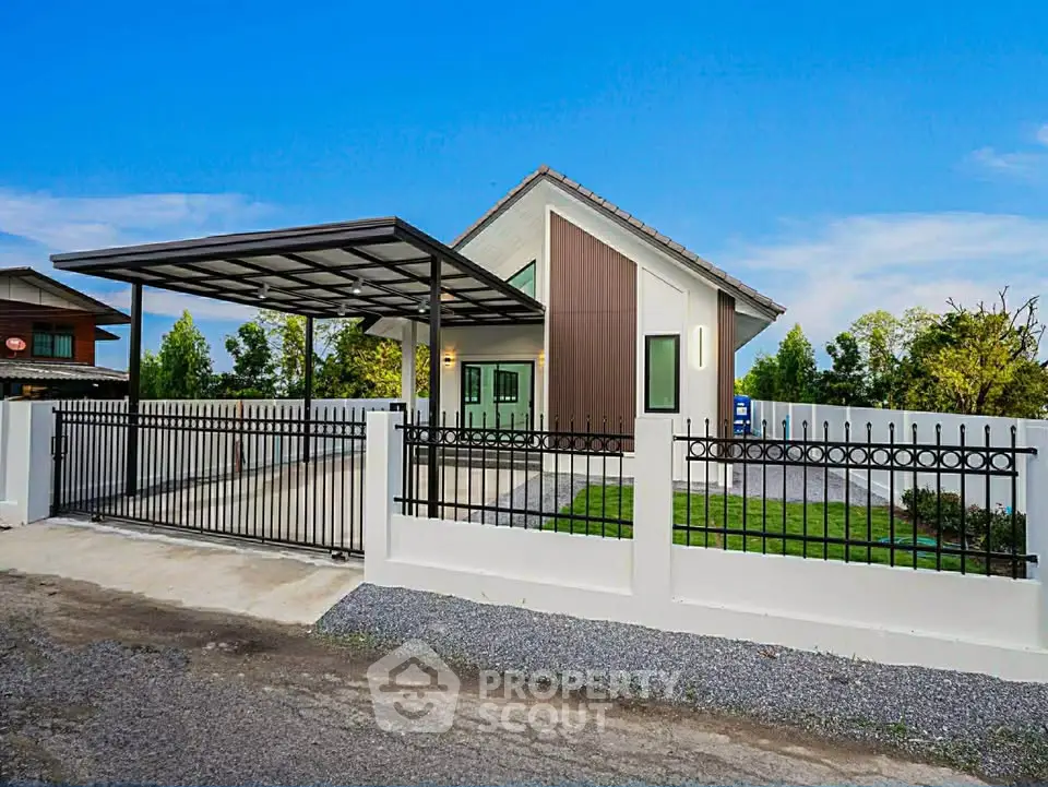 Modern single-story house with sleek design and spacious driveway in a serene neighborhood.