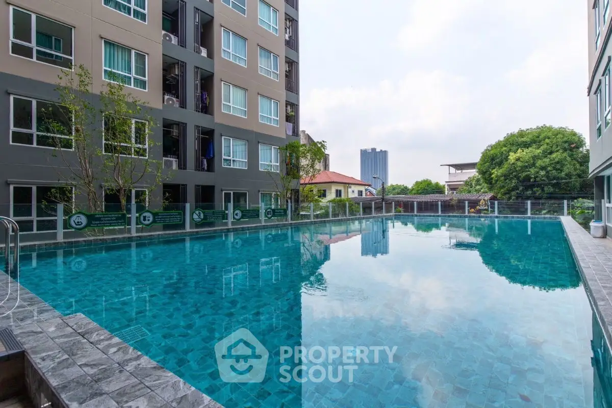 Luxurious apartment complex with a stunning outdoor pool and modern architecture.