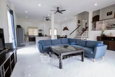 Spacious modern living room with open kitchen and stylish decor