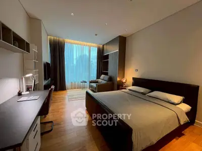 Luxurious bedroom with modern decor and city view, featuring a cozy workspace and elegant lighting.