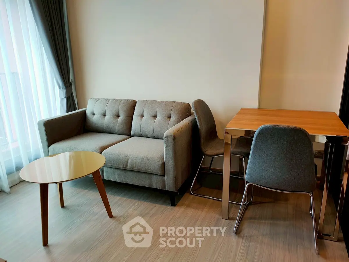 Modern living room with stylish sofa and dining table in a cozy apartment.