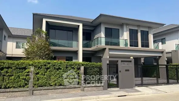 Modern two-story house with sleek design and spacious balcony in a serene neighborhood.