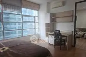 Bright bedroom with study area and large windows in modern apartment