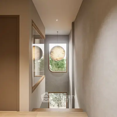 Modern staircase with elegant lighting and large windows offering natural light and serene views.