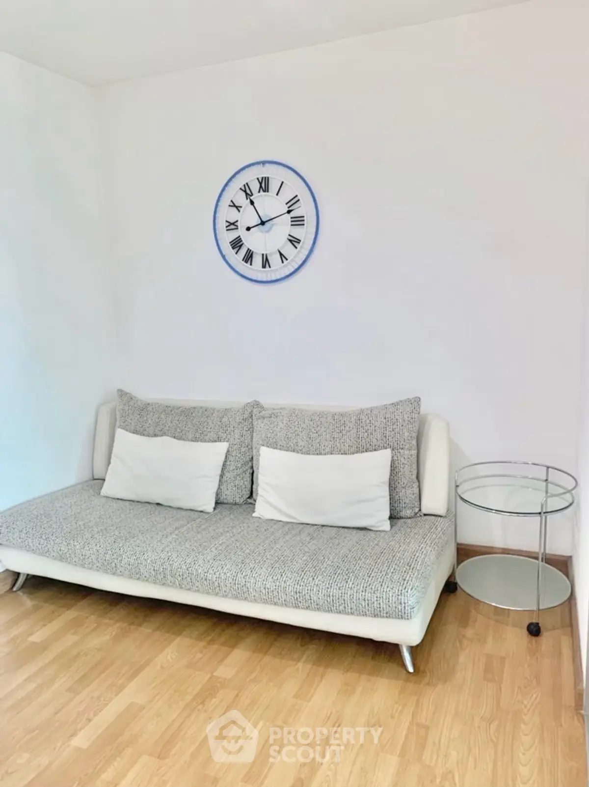 Modern living room with stylish sofa and wall clock