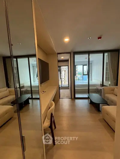 Spacious modern living room with elegant furniture and large windows for natural light.