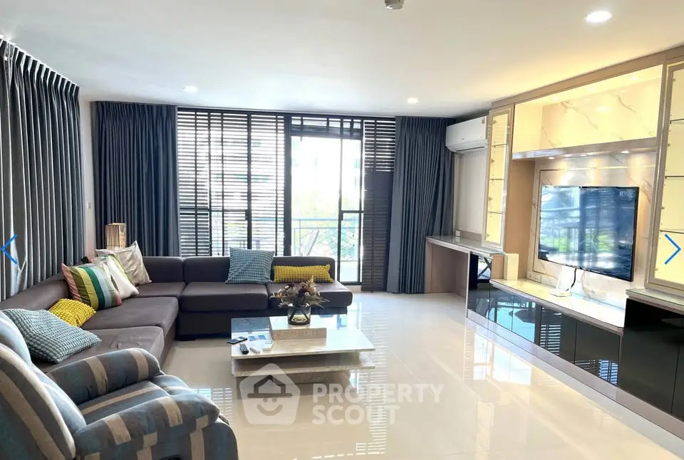 Spacious modern living room with large windows and stylish furniture