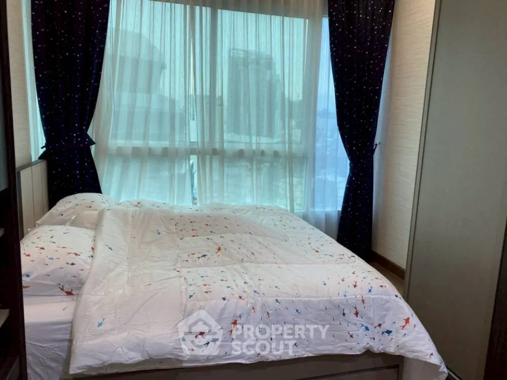 Cozy bedroom with city view and stylish curtains