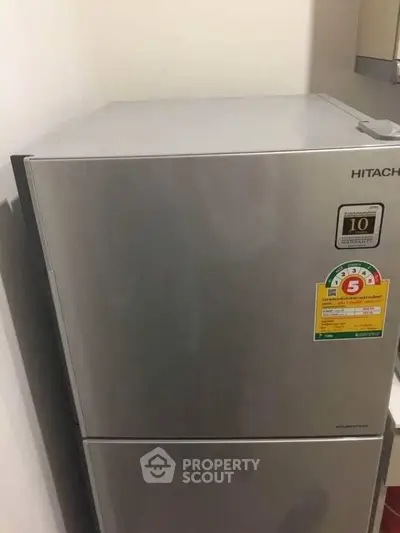 Modern stainless steel refrigerator in a sleek kitchen setting.