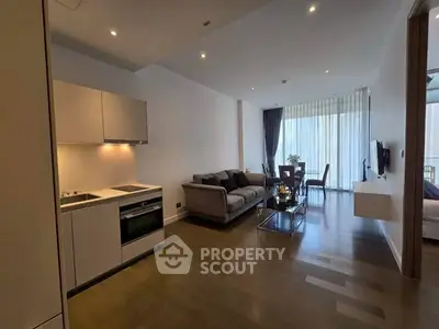 Modern open-plan living room with sleek kitchen and cozy seating area