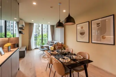 Modern living and dining area with stylish decor and balcony view