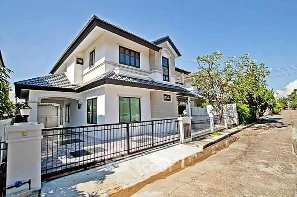 Stunning modern two-story house with sleek design and spacious driveway in a serene neighborhood.