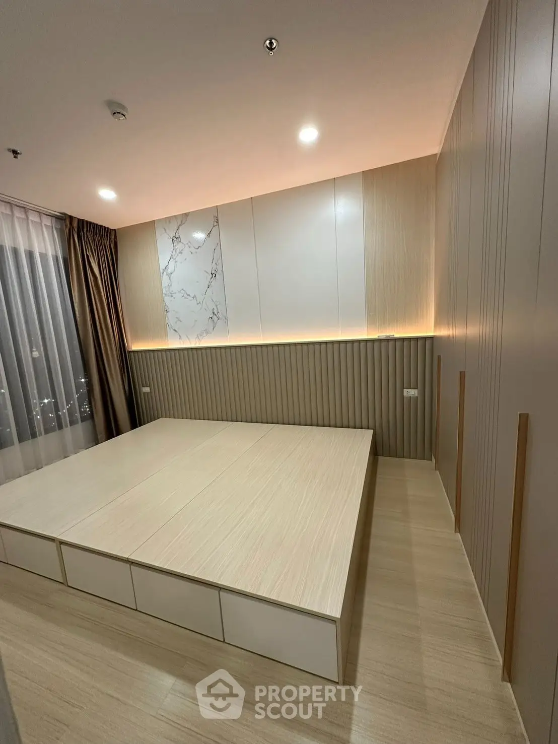 Modern minimalist bedroom with built-in storage and ambient lighting