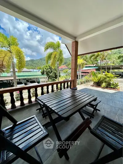 Spacious balcony with scenic mountain views and outdoor seating, perfect for relaxation.